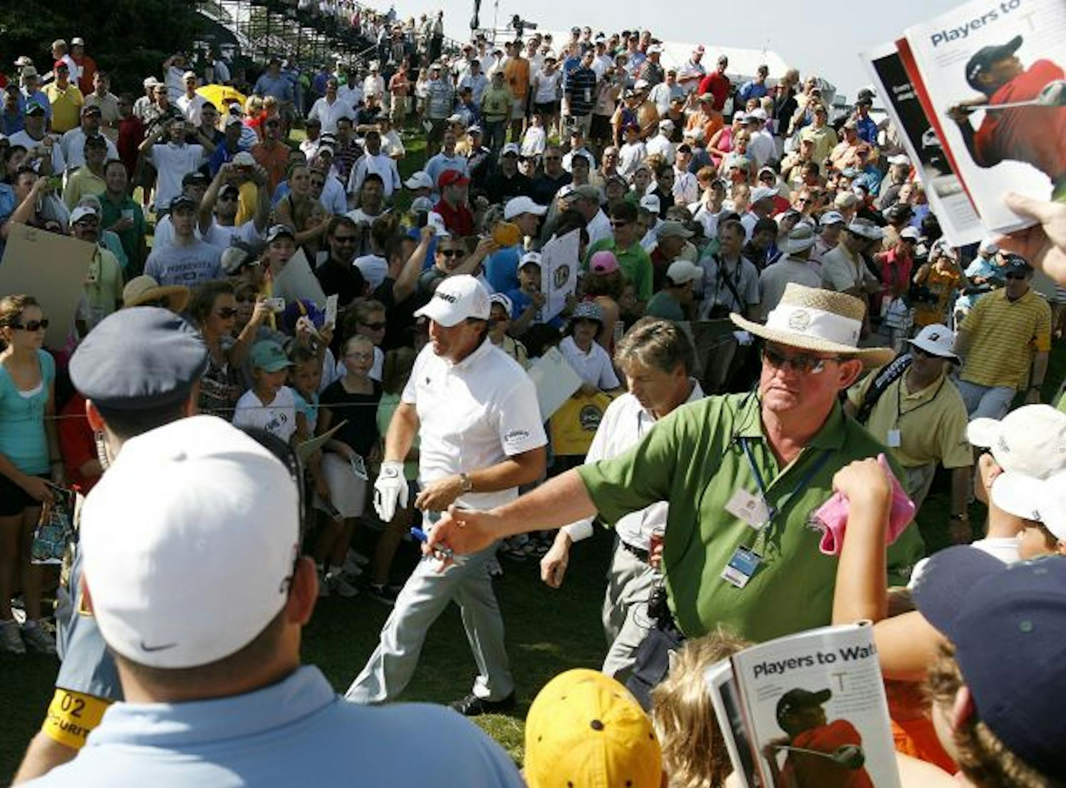 Phil Mickelson has a large following as he makes his way to the 2nd tee during the final practice round forPGA Championship at Hazeltine National Golf Club in Chaska, MN.
