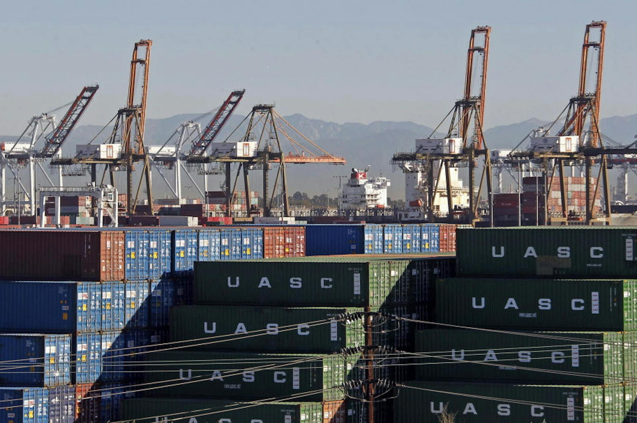 The Ports of Los Angeles and Long Beach, with some cargo loading cranes in the upright and idle position, are seen in this view from the San Pedro area of Los Angeles, Thursday, Feb. 12, 2015.
