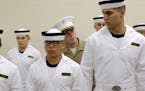 U.S. Marine Corps 2nd Lt. Ben Pope, center, inspects prospective plebes as they stand in formation during Induction Day at the U.S. Naval Academy, Wed