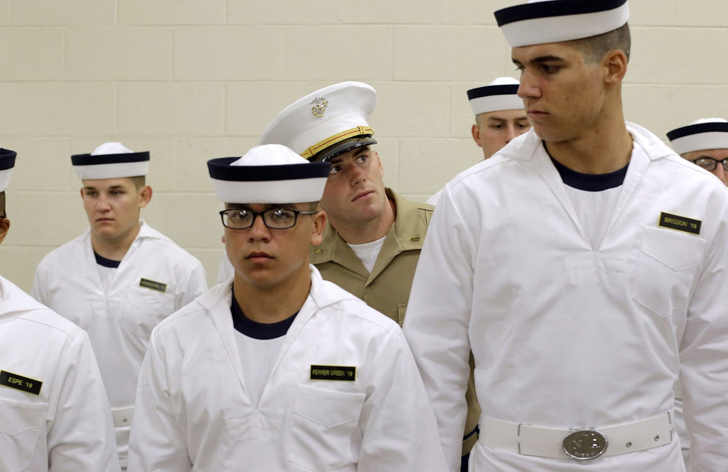 U.S. Marine Corps 2nd Lt. Ben Pope, center, inspects prospective plebes as they stand in formation during Induction Day at the U.S. Naval Academy, Wednesday, July 1, 2015, in Annapolis, Md. More than 1,100 young men and women reported for "I-Day," where they received haircuts, medical examinations, new uniforms and instructions on how to salute and address superiors before taking an oath of office to become members of academy's newest class. (AP Photo/Patrick Semansky) ORG XMIT: MDPS103