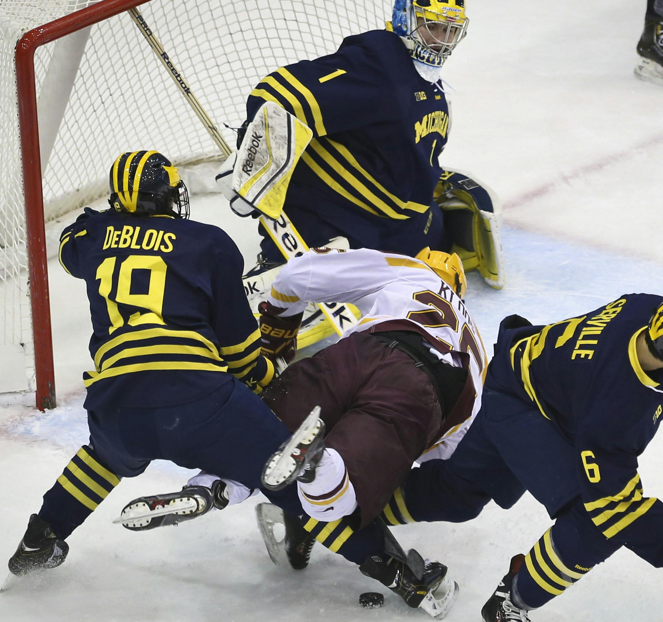 Minnesota's Justin Kloos lost the chance to score on Michigan goalie Steve Racine as he was squeezed by Michigan's Derek DeBlois (19) and Brennan Serville (6)during the first period of the MInnesota Gophers men's hockey vs. Michigan Wolverines on Friday, February 14, 2014 in Minneapolis, Minn. ] (RENEE JONES SCHNEIDER reneejones@startribune.com)