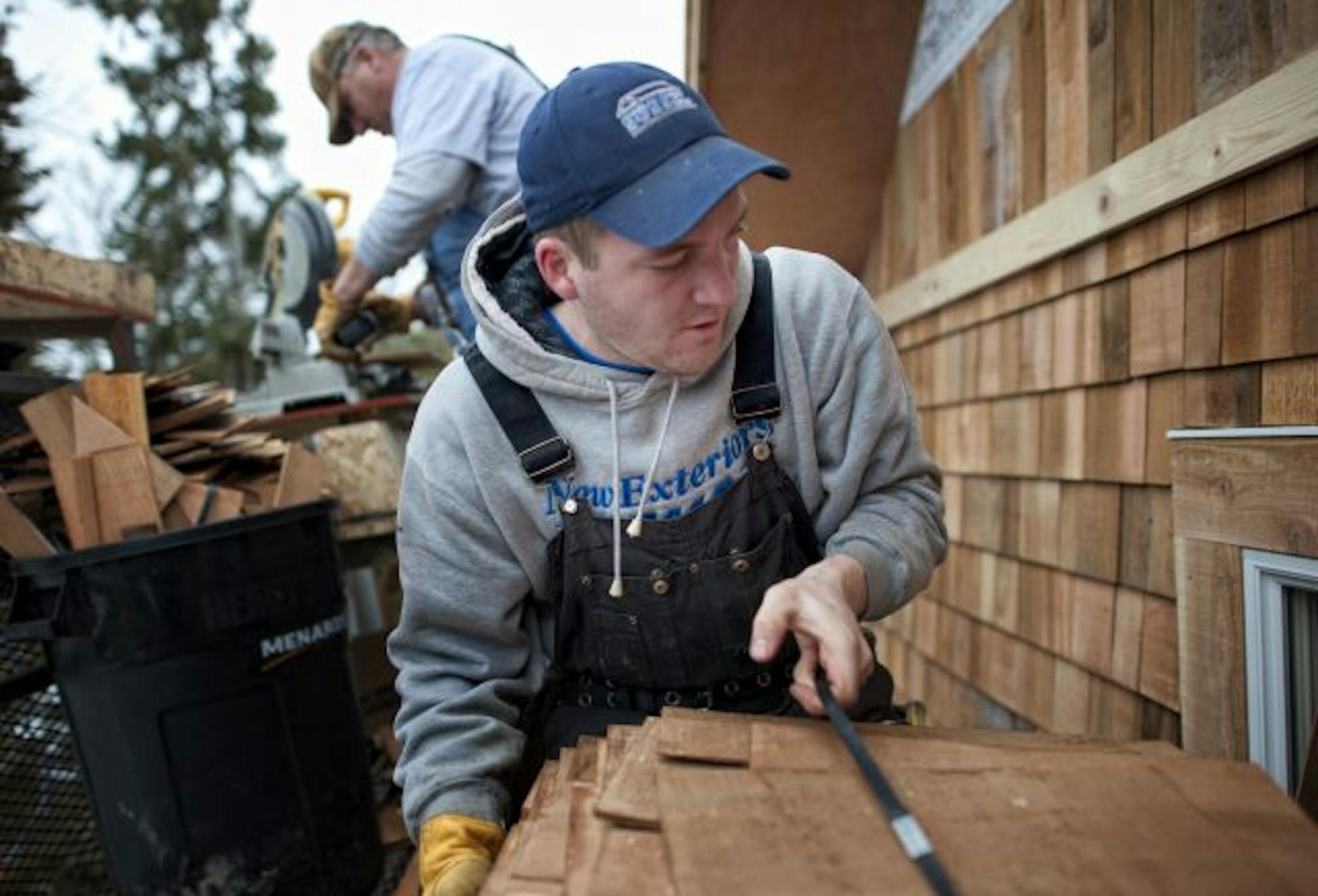 Bruce and Adam Sames installed cedar shingles on a new construction home in Minneapolis. Employers hired in February at the fastest pace in almost a year and the unemployment rate fell to 8.9 percent — a nearly two-year low.The economy added 192,000 jobs last month, with factories, professional and business services, education and health care among those expanding employment. Retailers, however, trimmed jobs. State and local governments, wrestling with budget shortfalls, slashed 30,000 jobs, th