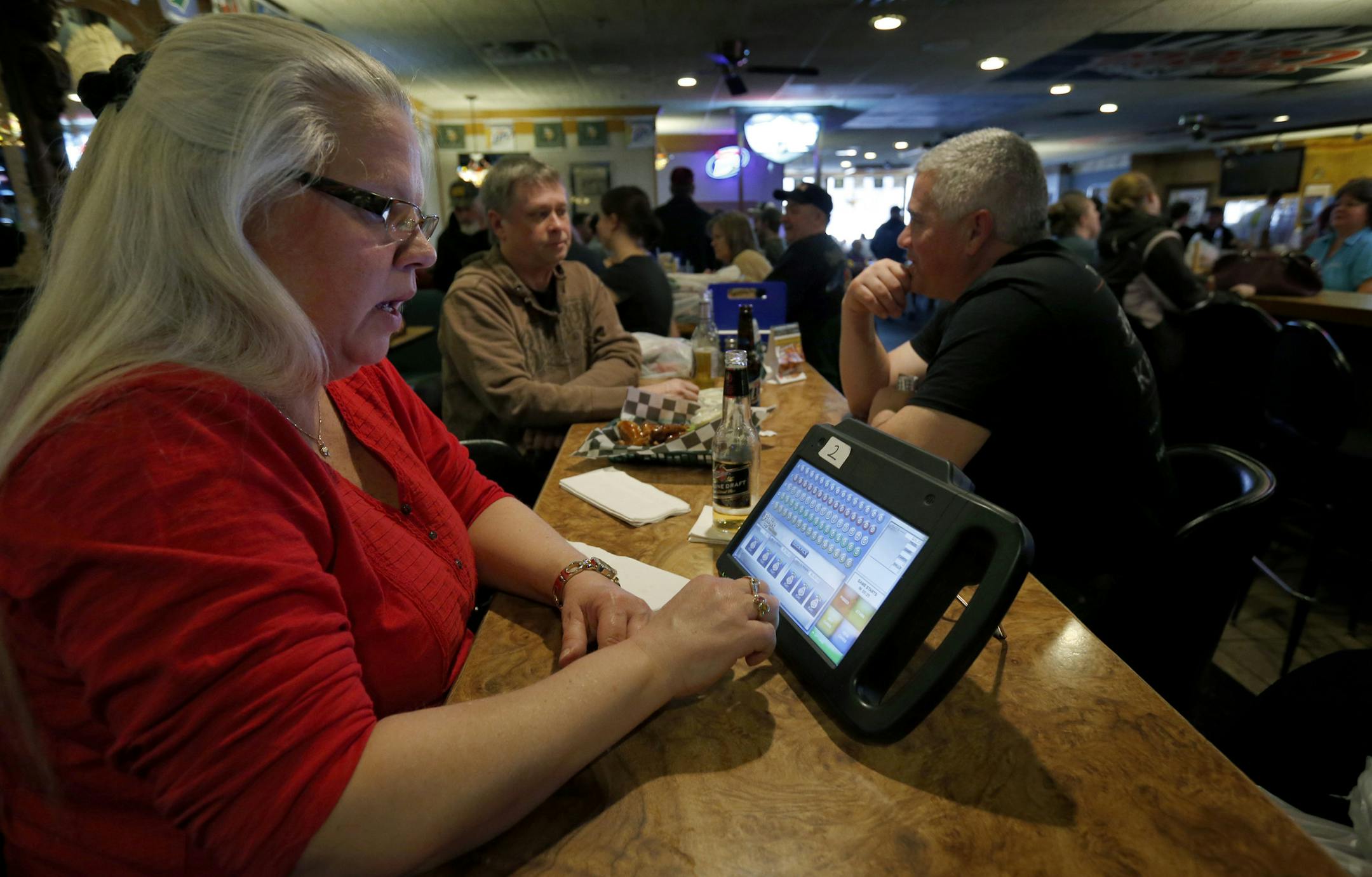 Rona Nesser, of Blaine played electronic bingo at the Blainebrook Entertainment Center in Blaine on Thursday. ] CARLOS GONZALEZ cgonzalez@startribune.com March 27, 2013, Blaine, Minn., The Blainebrook Entertainment Center is one of the two or three test sites for the new electronic linked bingo games. Electronic linked bingo, the second leg of Minnesota's plan to fund the Minnesota Vikings stadium, is expected to begin rolling out at bars and restaurants this week.