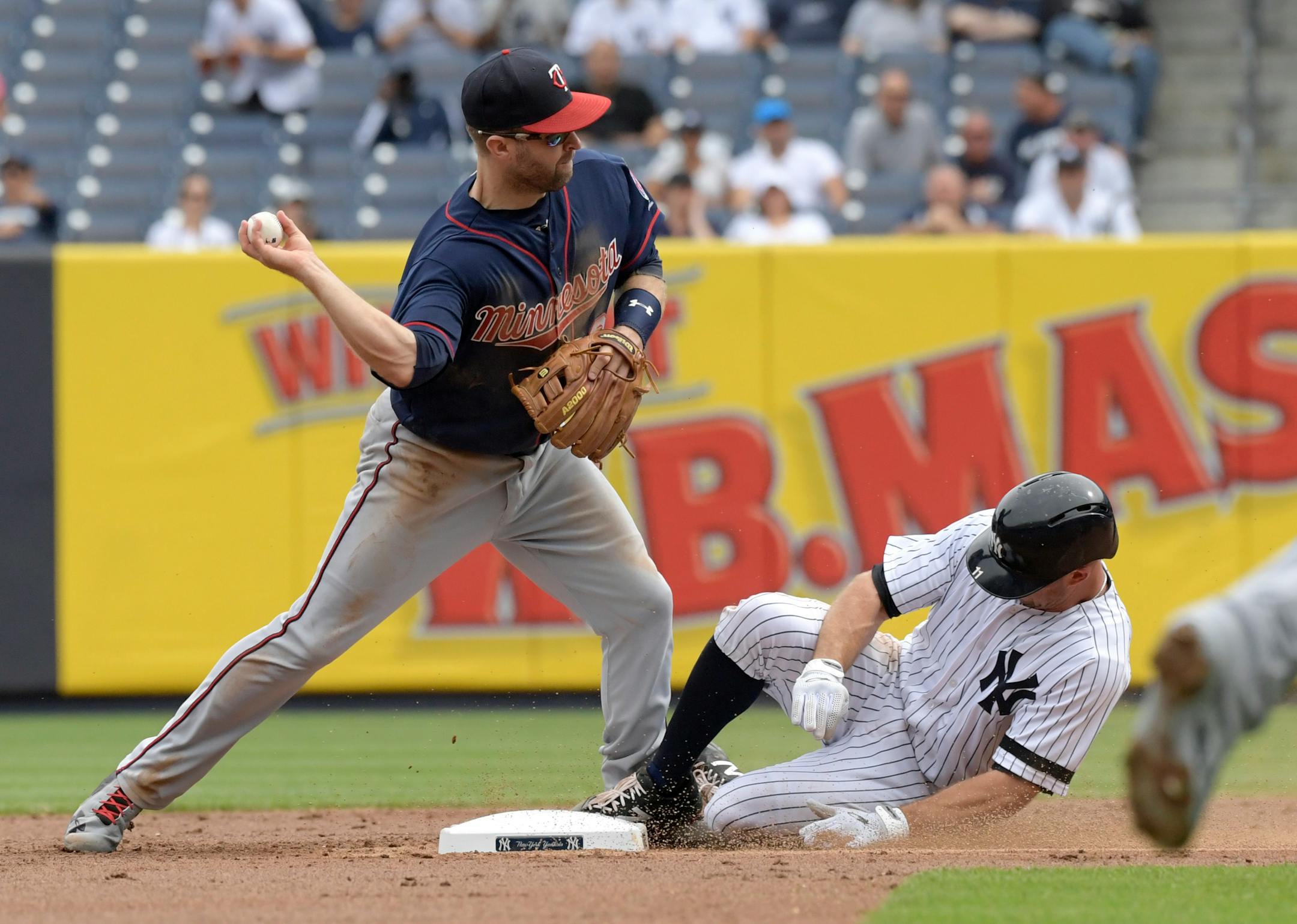 New York Yankees' Brett Gardner, right, is out at second on a fielder's choice as Minnesota Twins second baseman Brian Dozier, left, relays the ball to first attempting to complete the double play during the first inning of a baseball game Wednesday, Sept. 20, 2017, at Yankee Stadium in New York. The throw to first was not in time. (AP Photo/Bill Kostroun)