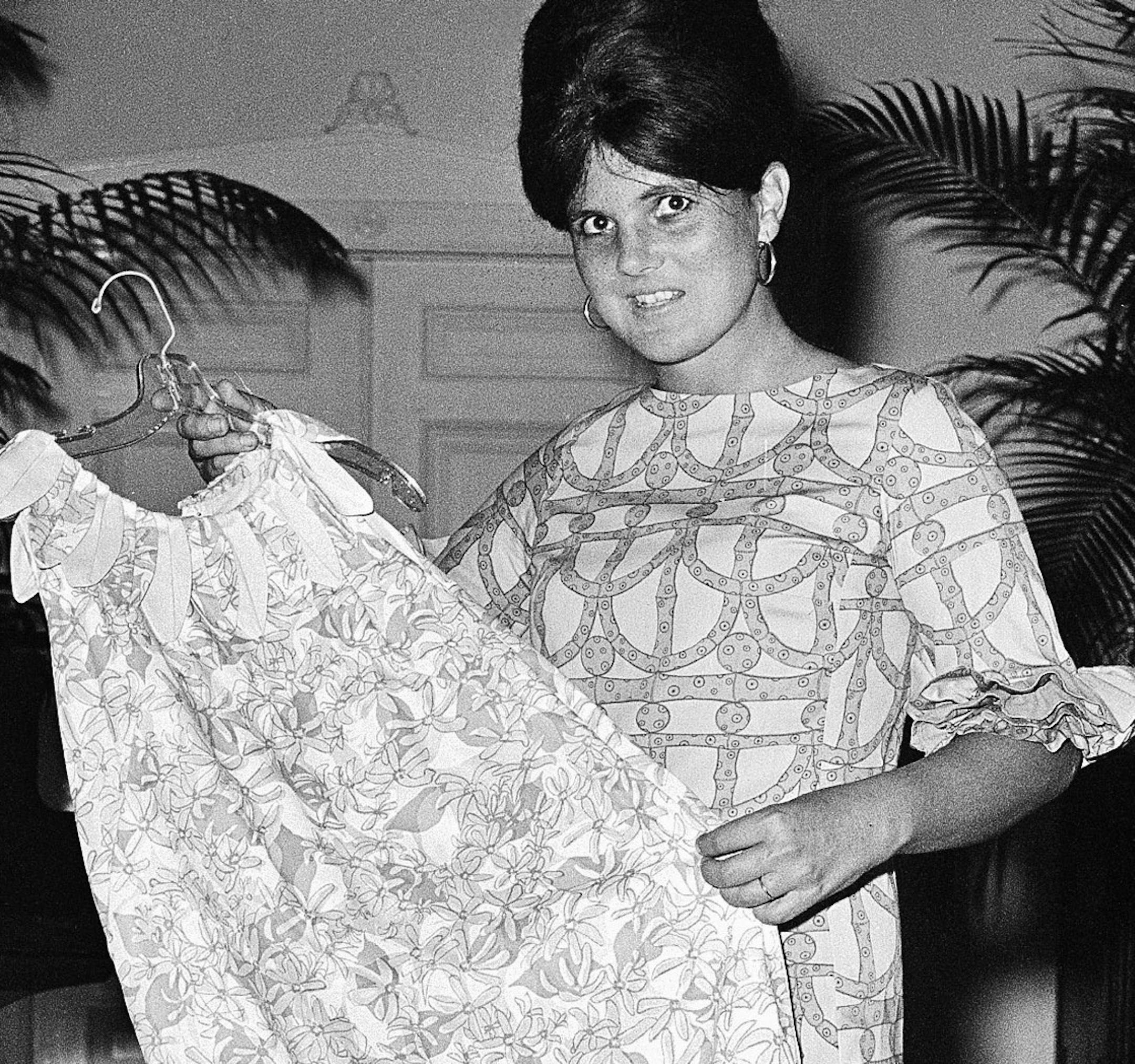FILE - In this March 16, 1965 file photo, Palm Beach the fashion designer Lilly Pulitzer, wears her own design and creation of the Lilly shift, in Palm Beach, Fla. Pulitzer, known for her tropical print dresses, dies in Florida at 81. (AP Photo/Robert H. Houston, File)