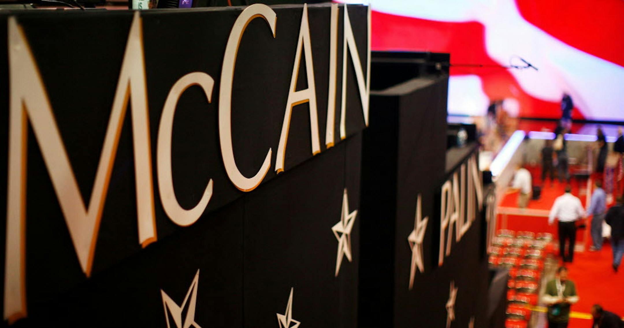 Signs reading "McCain - Palin" hang off a riser as workers prepare the newly arranged stage in the morning of day four of the Republican National Convention today.