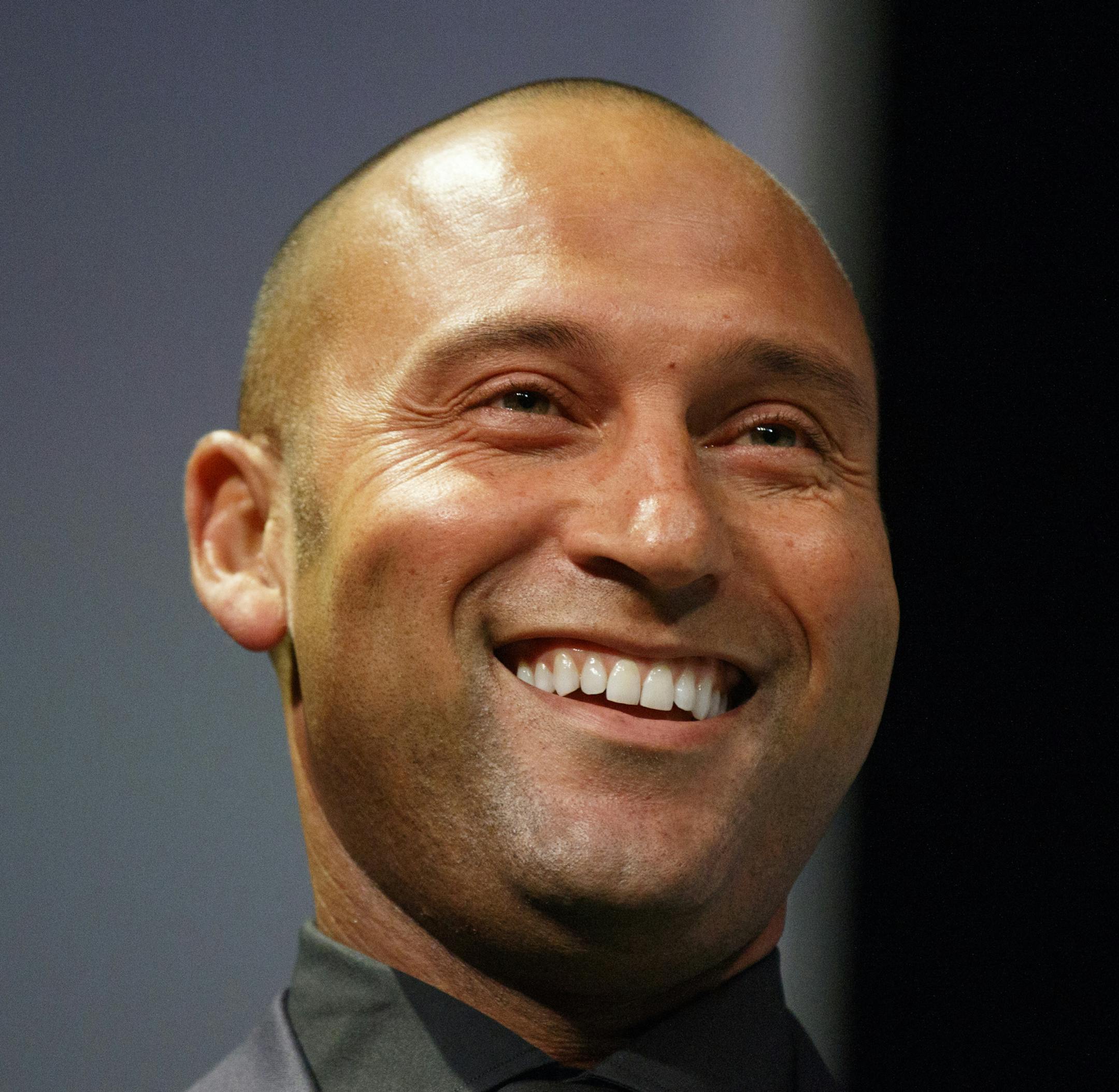 In this photo taken Tuesday, May 26, 2015, fetired baseball star Derek Jeter shares a laugh during The 28th Annual Economics Club of Grand Rapids awards dinner at DeVos Place in Grand Rapids, Mich. (Hugh Carey/The Grand Rapids Press via AP) ALL LOCAL TELEVISION OUT; LOCAL TELEVISION INTERNET OUT