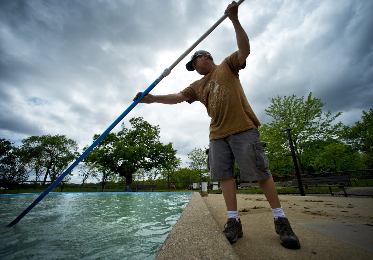 A park keeper worked on getting the Pearl Park pool in Minneapolis ready for the season opening in 2013. Correction: A previous photo showed Gold Medal Park in Minneapolis, which is not part of the Minneapolis parks system.