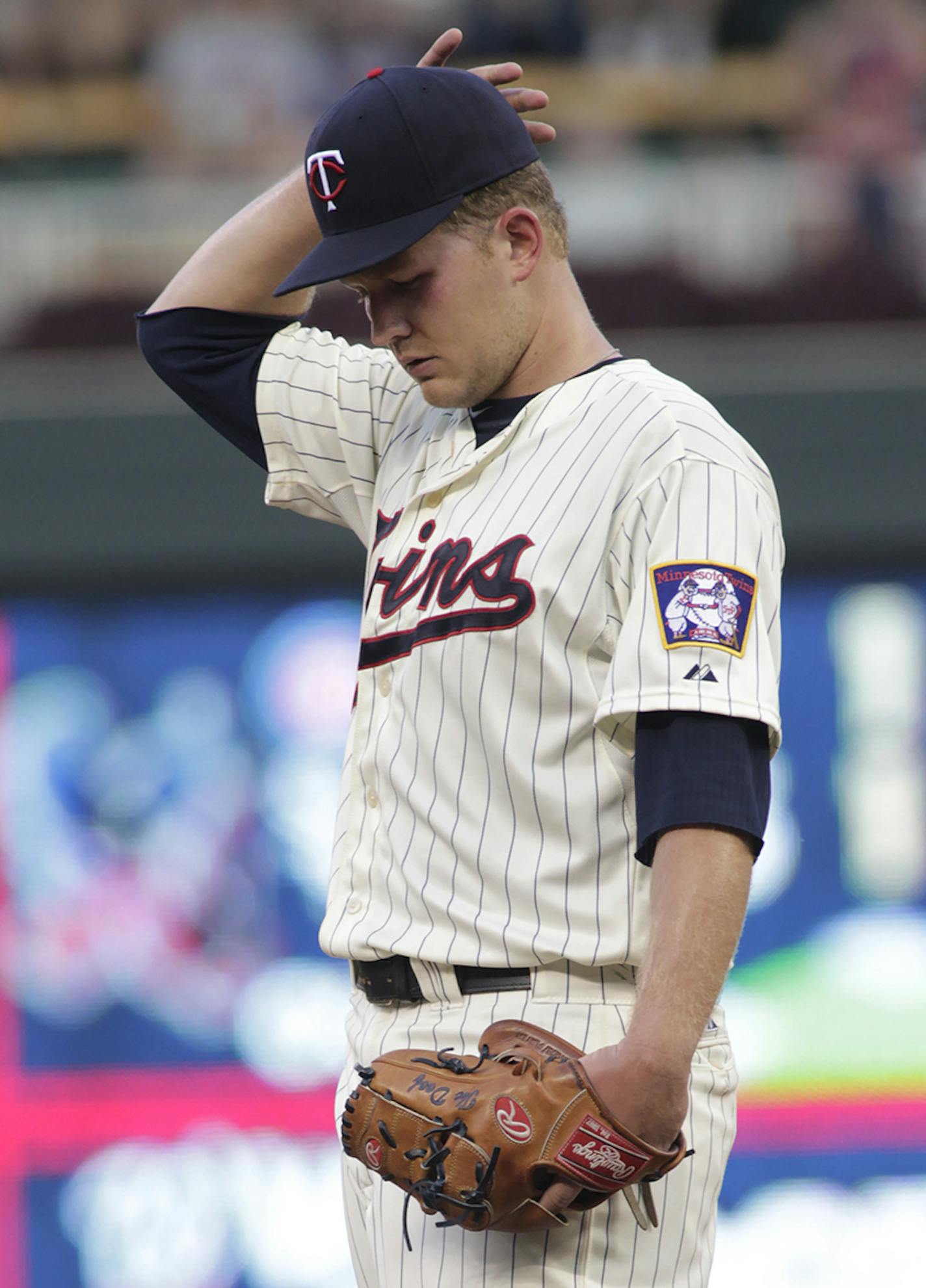 Minnesota Twins starting pitcher Tyler Duffey adjusts his cap during the fifth inning of a baseball game against the Cleveland Indians on Saturday, Aug. 15, 2015, in Minneapolis. Duffy picked up his first win in the majors as the Twins won 4-1. AP Photo/Paul Battaglia)