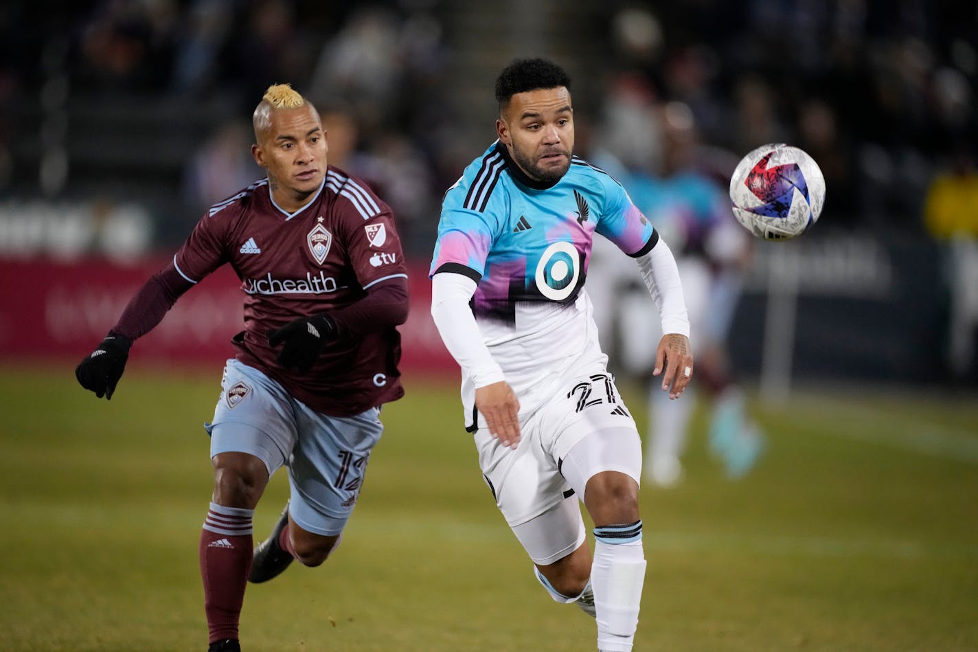 Minnesota United defender D.J. Taylor, right, pursues the ball with Colorado Rapids forward Michael Barrios during the first half Saturday