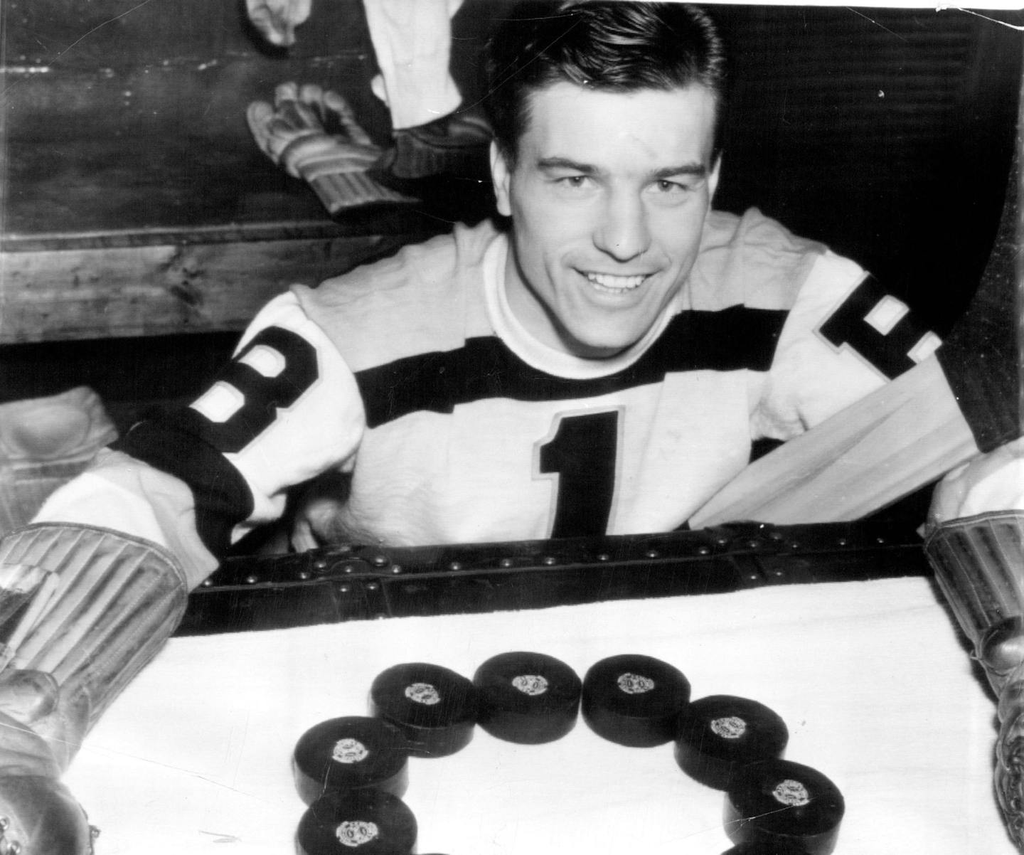 Hockey's newest sensation, Goalie Frank Brimsek of the Boston Bruins, is shown posing here to demonstrate how he has guarded his team's goal and failed to allow a single score in six of the seven games in which he has played since "coming up" from Providence. Frankie, who hails from Eveleth, Minn., is modest about it, though, and cites the fine playing of his teammates for the reason that the Bruins are leading the league. December 20, 1938 AP Wirephoto (Photo also ran May 1, 1970 )