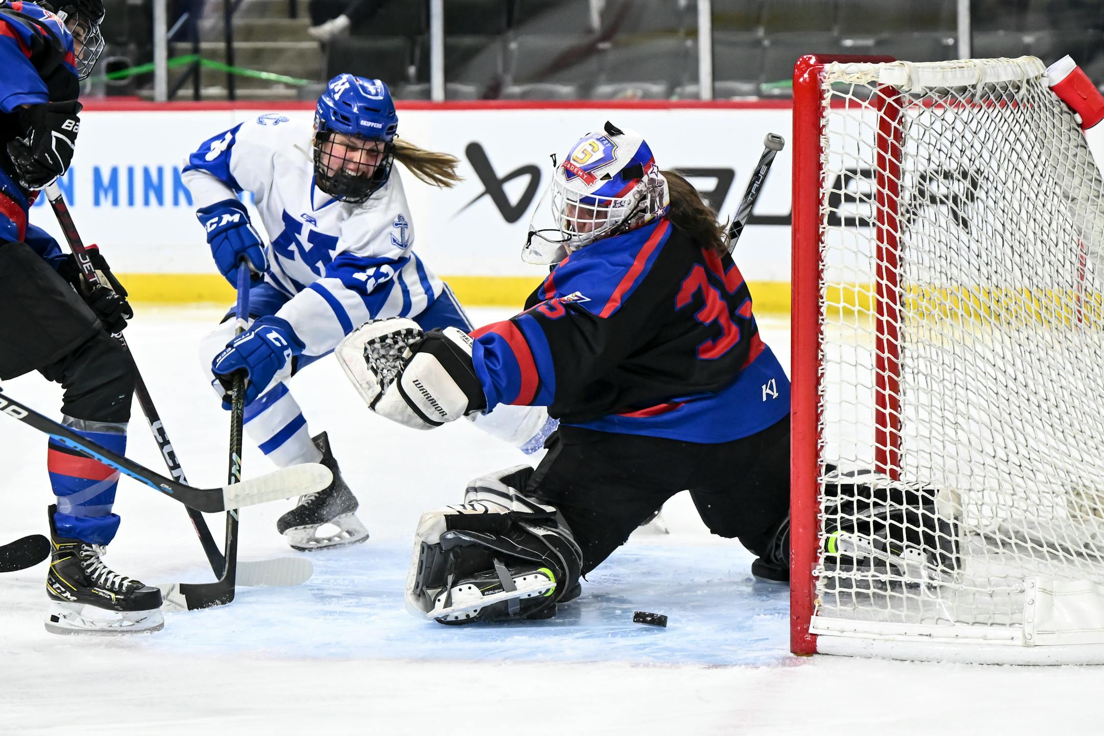 Minnetonka forward Lindzi Avar (13) looks to score but is unable to finish against Gentry goaltender Zoe Laming (35) during the first period.