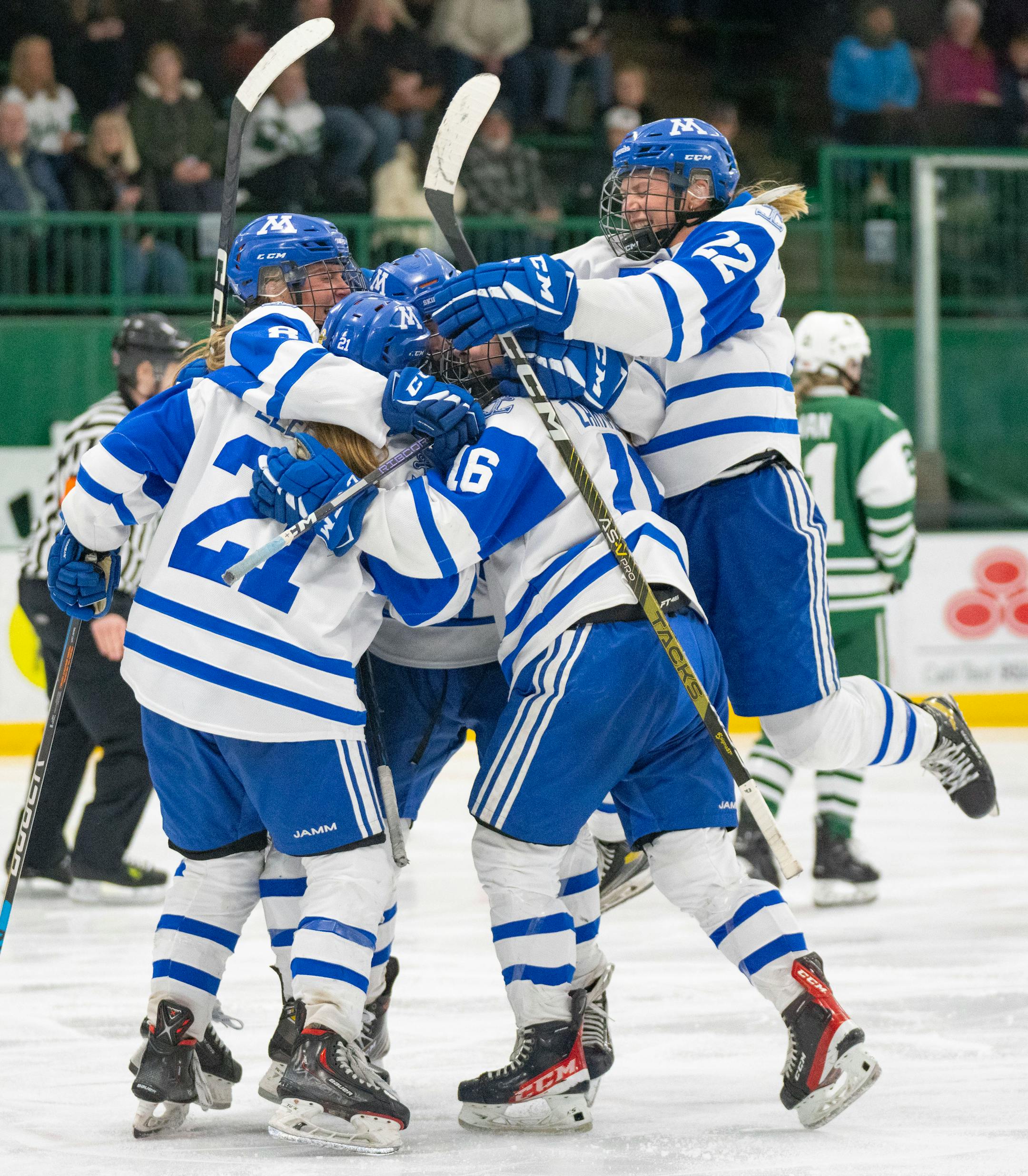 Minnetonka players celebrate with forward Senja Leeper (21) after she scored a goal against Holy Family in the third period.