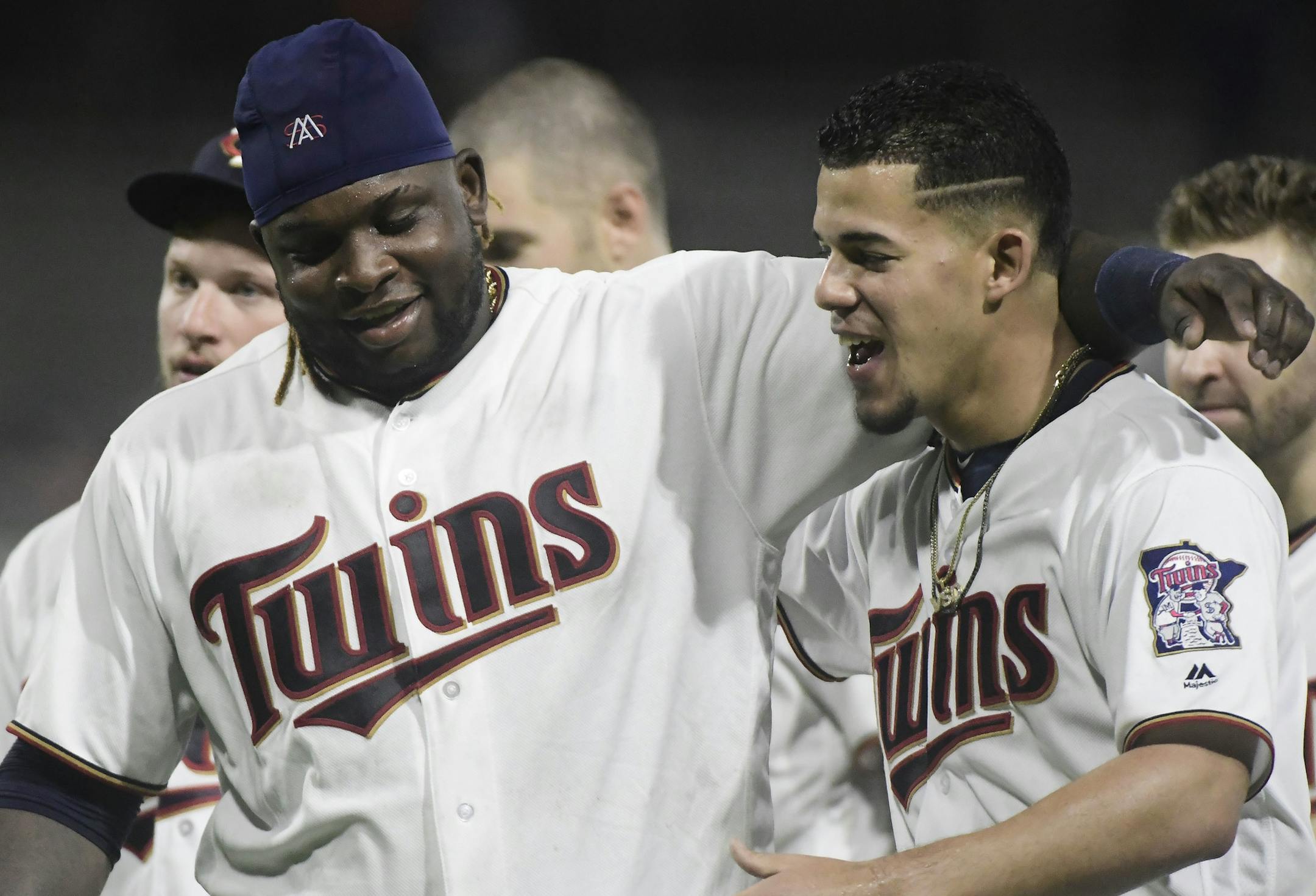 Minnesota Twins starting pitcher Jose Berrios, right, and third baseman Miguel Sano celebrate the team's 2-1 win over the Cleveland Indians in 16 innings in a baseball game at Hiram Bithorn Stadium in San Juan, Puerto Rico, early Thursday, April 19, 2018. (AP Photo/Carlos Giusti)