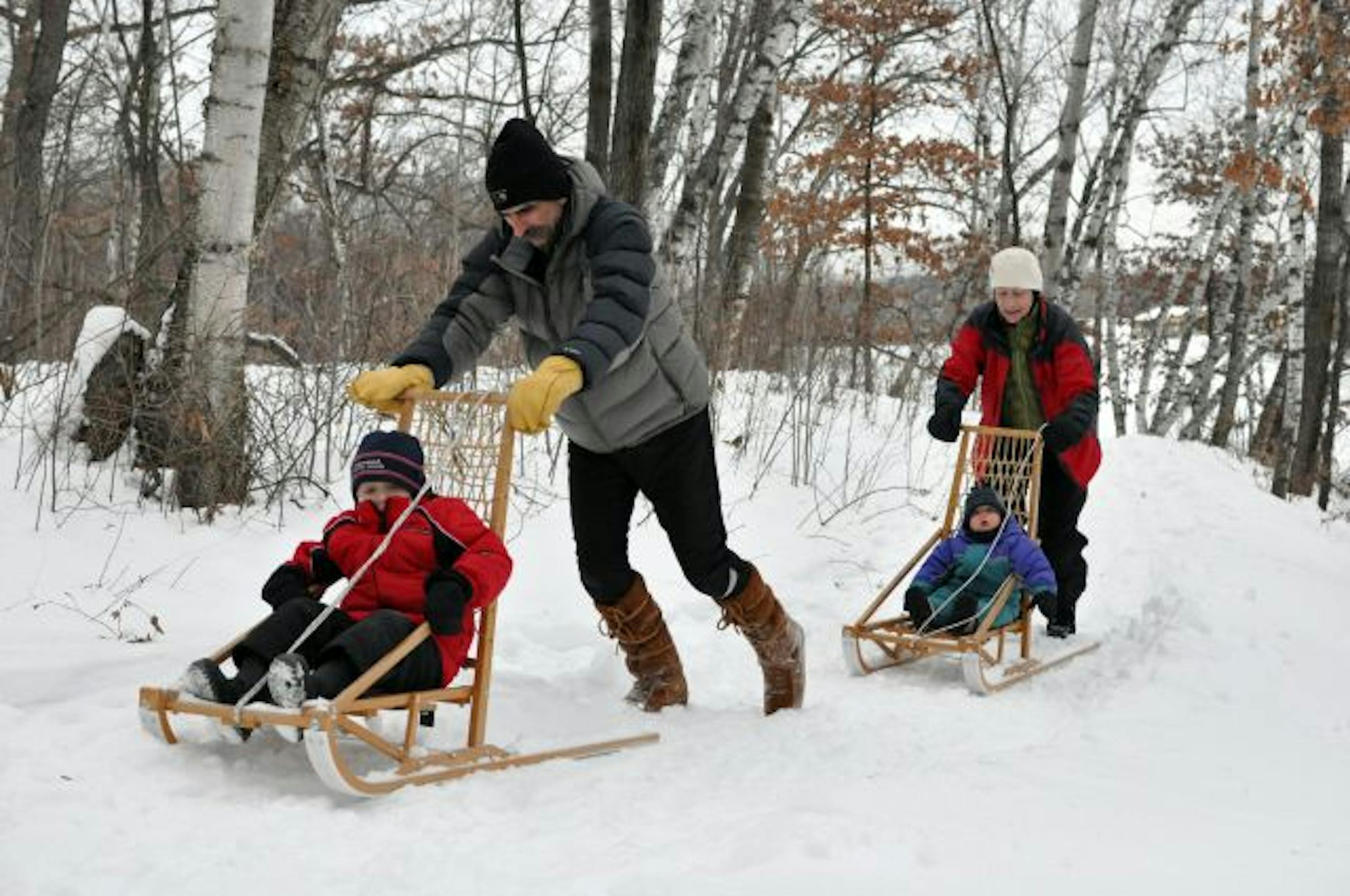 Photo by Liz RolfsmeierKen and Cheryl Drivdahl of Northfield pushed their grandsons, Conor, 1, and Joshua, 4, on kicksleds at Lebanon Hills Park in Eagan.