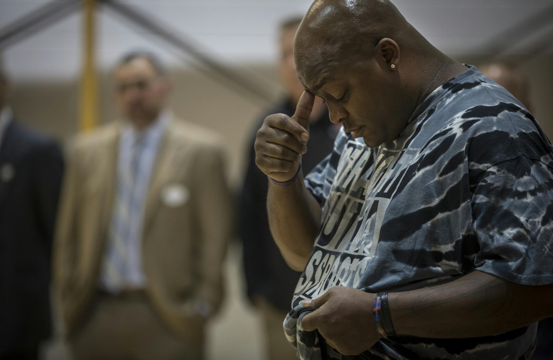 Grassroots Hoops Club founder Brian Sandifer teared up talking about his father who was the inspiration for his athletics club at High School for Recording Arts in St. Paul, Minn. on Wednesday, April 20, 2016. ] RENEE JONES SCHNEIDER * reneejones@startribune.com St. Paul cop Tom Reis noticed kids at a school where he worked off-duty were playing basketball in street shoes. He raised money to buy them basketball sneakers and handed them out with other cops Wednesday at High School for Recording A