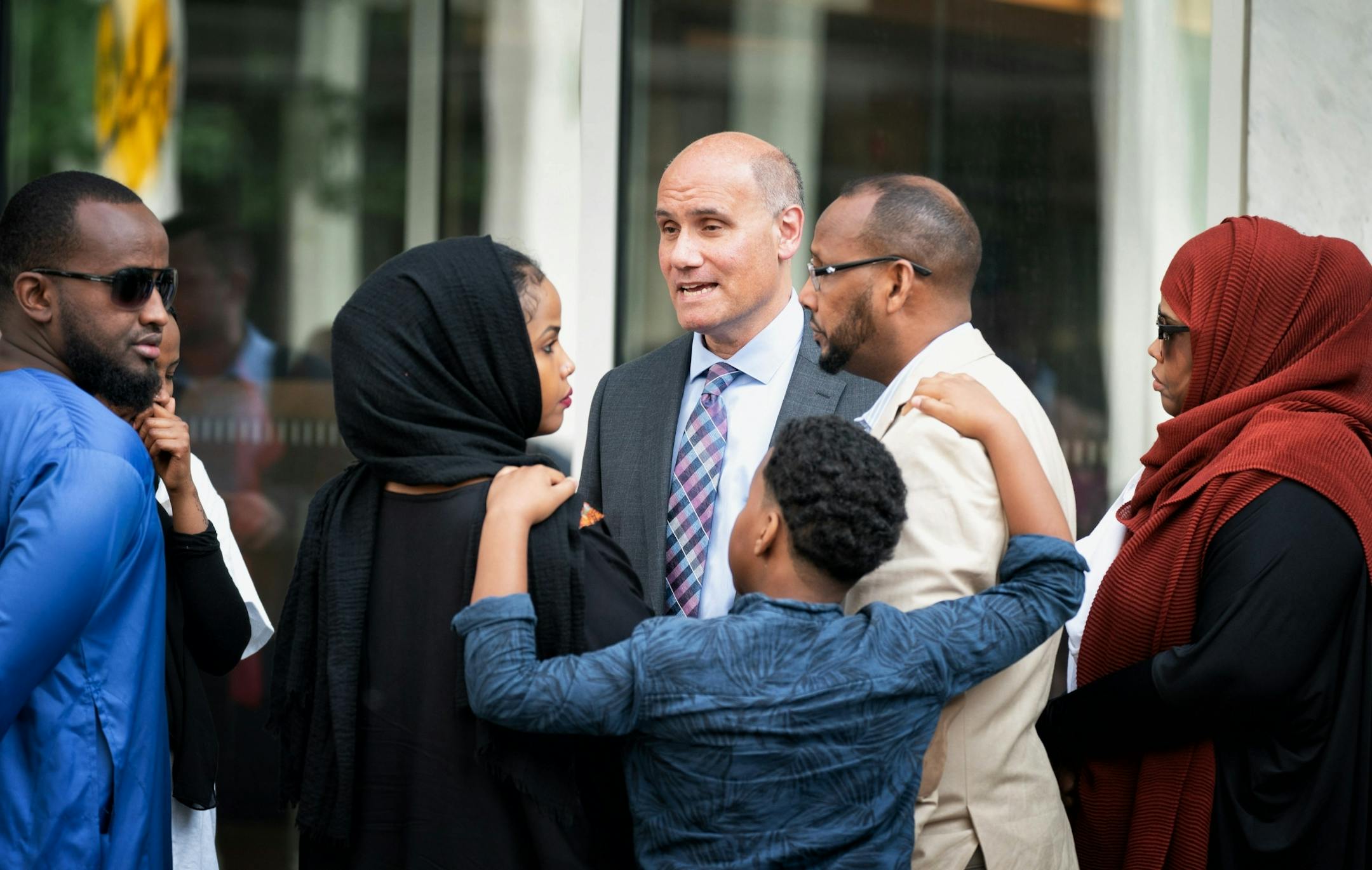 Attorney Jordan Kushner talked with family members of his client Mohamed Farah. On the right are Farah's parents Abdi Hamid Farah and mother Ayan Farah. Center left is sister and younger brother Abdi Rahim Farah.