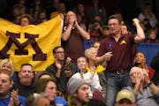 University of Minnesota fans cheer on the women's gymnastics team.