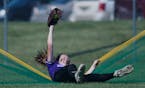 Buffalo outfielder Jordan Zrust (6) falls as she makes a catch to steal a home run in the third inning. Buffalo defeated Woodbury 3-1 in the state hig