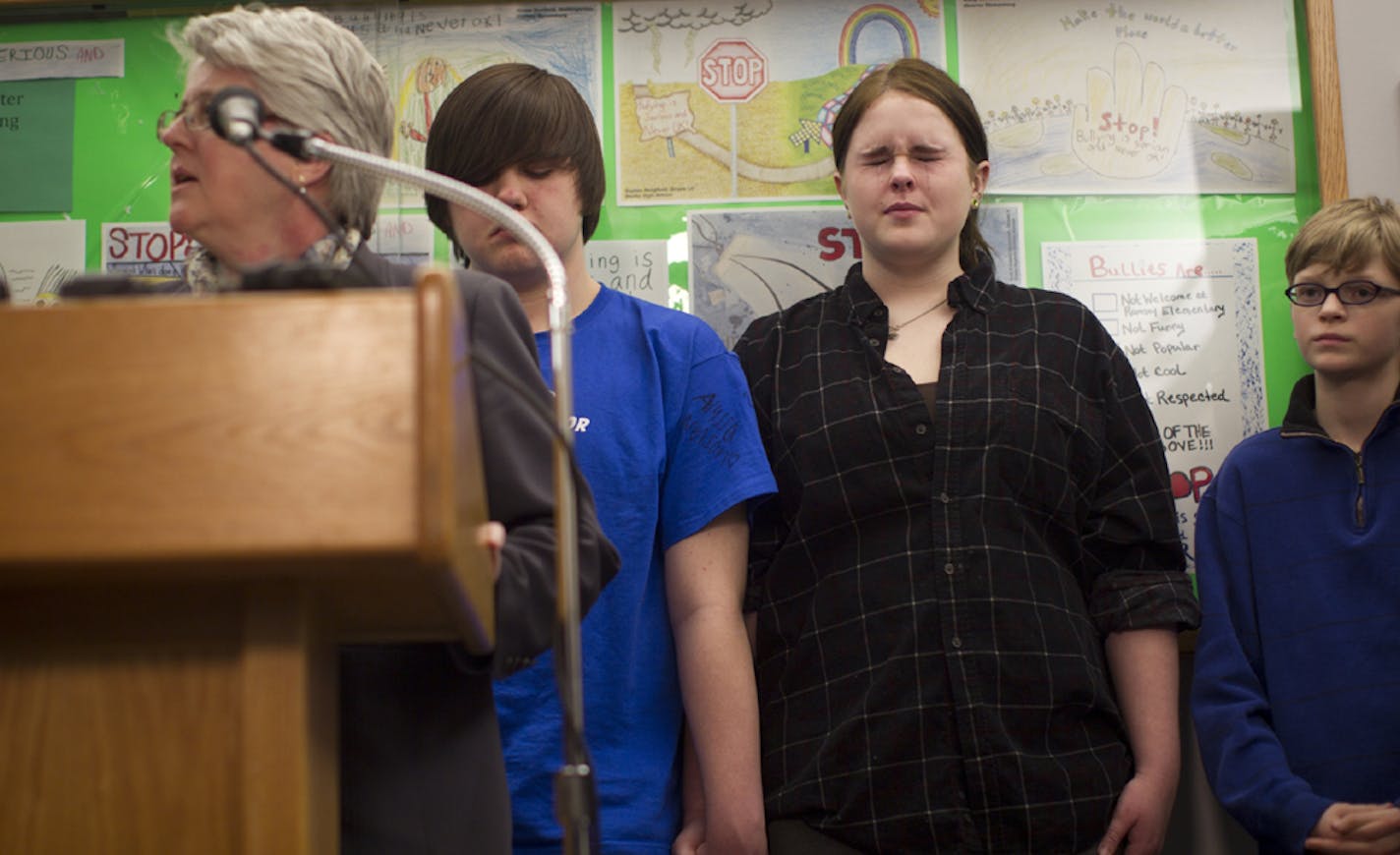 Plaintiffs Dylon Frei (in T-shirt) , Brittany Geldert and Kyle Rooker listened as Anoka-Hennepin officials announced the settlement.