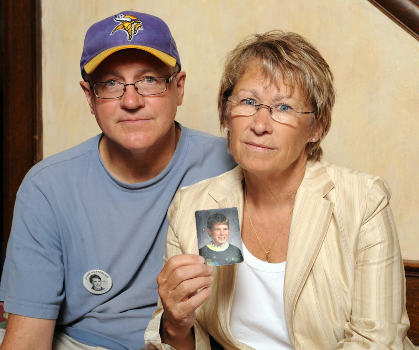 FILE - In this Aug. 28, 2009, file photo, Patty and Jerry Wetterling show a photo of their son Jacob Wetterling, who was abducted in October of 1989 in St. Joseph, Minn and is still missing, in Minneapolis. Patty Wetterling said Saturday, Sept. 3, 2016 that his remains have been found. Daniel Heinrich, who authorities have called a person of interest in the 1989 kidnapping, denied any involvement and was not charged with that crime. But he has pleaded not guilty to several federal child pornogra