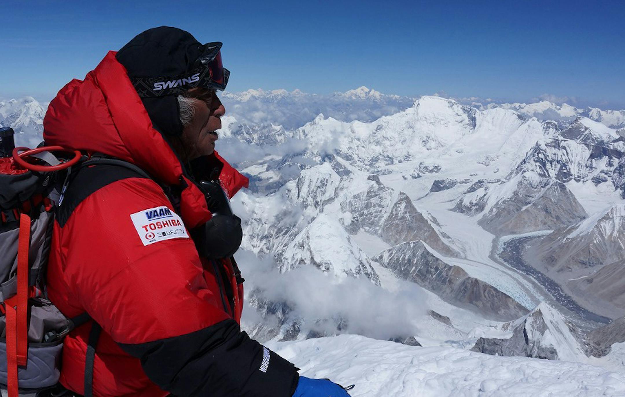 In this photo distributed by MIURA DOLPHINS CO., LTD., 80-year-old Japanese extreme skier Yuichiro Miura, right, who has had four heart operations in recent years, stands atop the summit of Mount Everest as he becomes the oldest person to climb the world's tallest mountain Thursday, May 23, 2013. Miura, who also conquered the 29,035-foot (8,850-meter) peak when he was 70 and 75, reached the summit at 9:05 a.m. local time, according to a Nepalese mountaineering official and Miura's Tokyo-based su