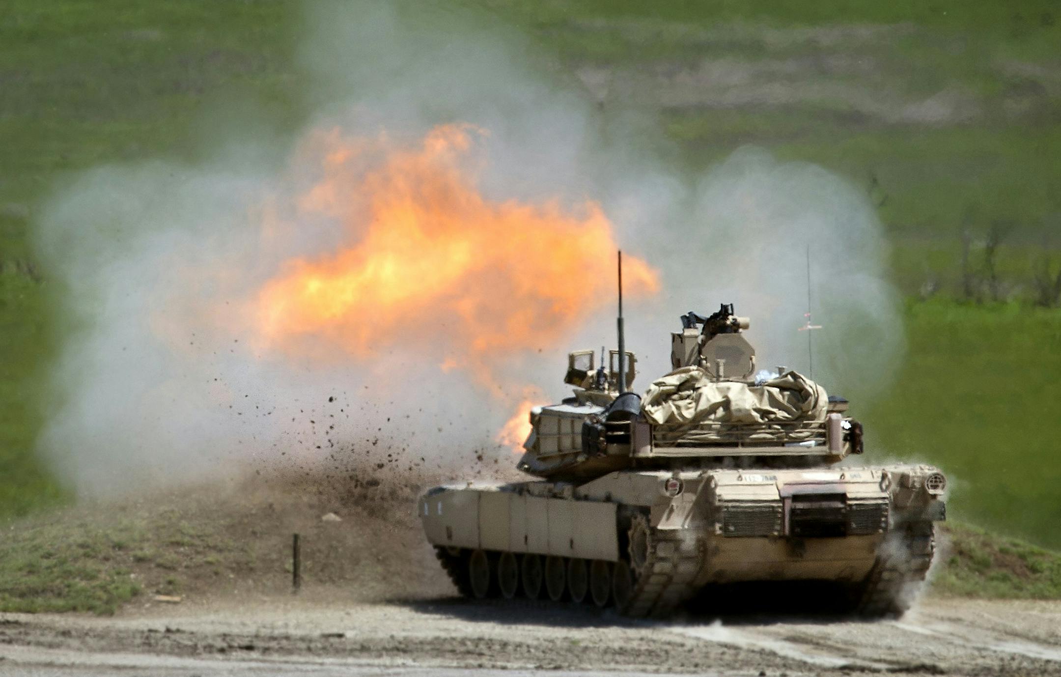 A M1A2 Abrams tank fires at a target during training exercises on Thursday, May 21, 2015, at Fort Riley in Kansas. (Keith Myers/Kansas City Star/TNS)