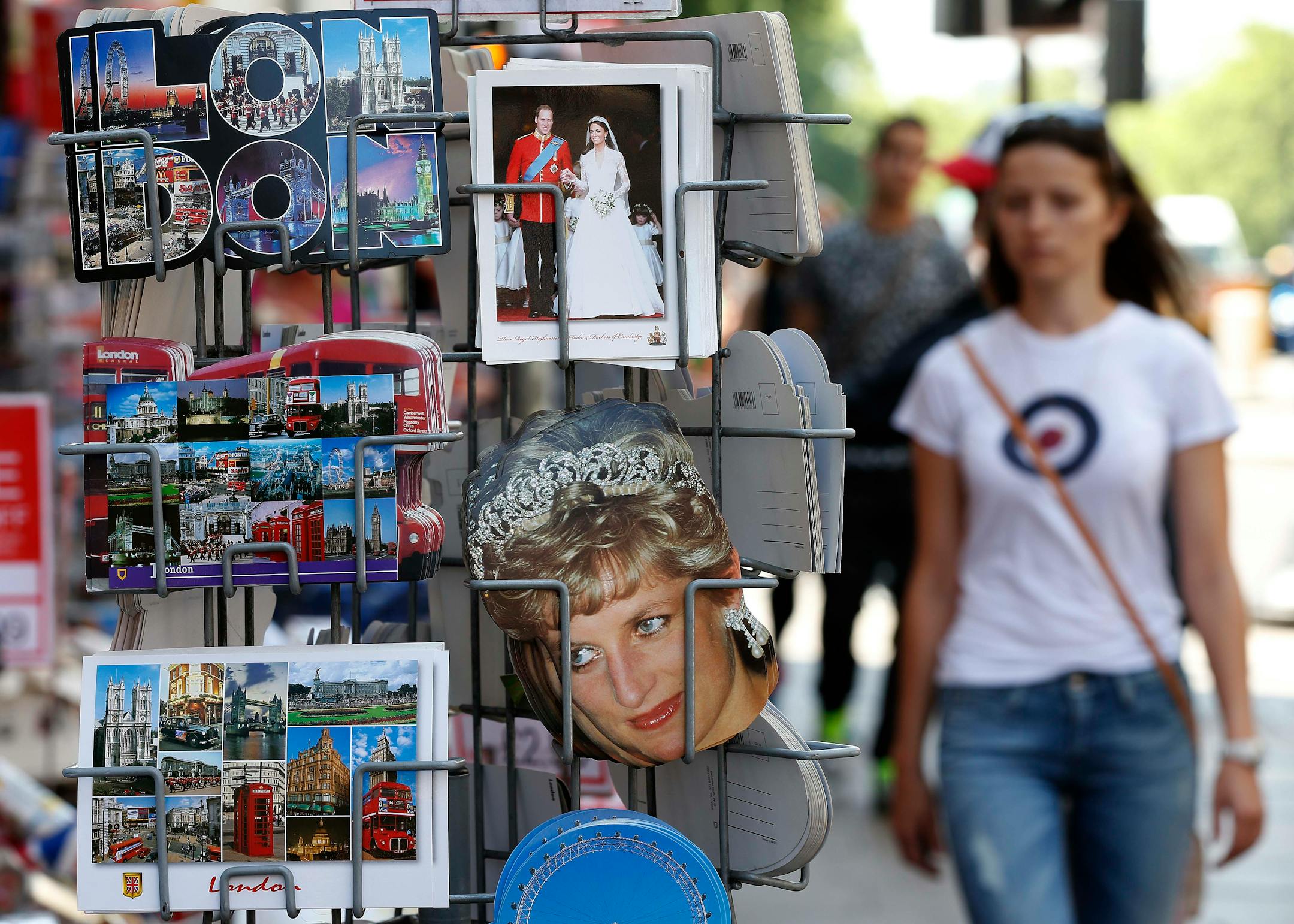 Royal souvenirs and postcards are displayed outside a shop in London, Monday, July 8, 2013. Britain's Prince William and his wife Kate are expecting their first child to be born in mid-July.