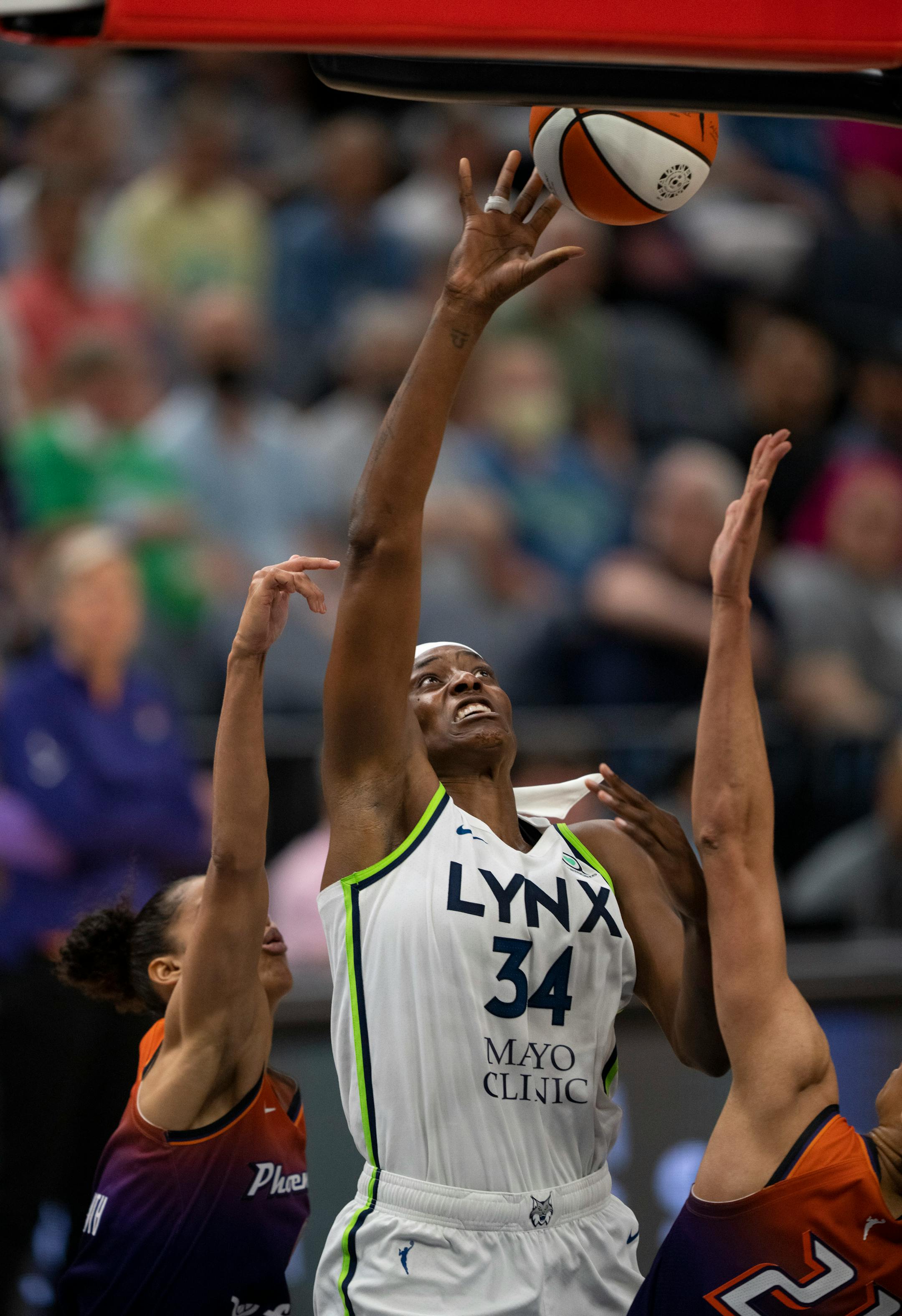 Minnesota Lynx center Sylvia Fowles (34) battled with two Phoenix defenders to get a fourth quarter shot.