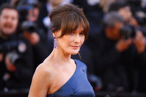 Former model Carla Bruni-Sarkozy poses for photographers upon arrival at the premiere of the film 'Les Miserables' at the 72nd international film fest