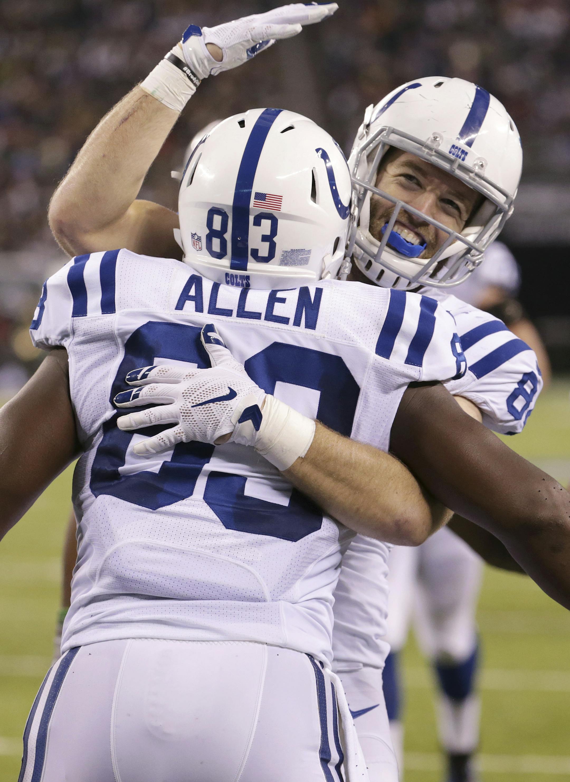 Indianapolis Colts tight end Dwayne Allen, left, is hugged by teammate Jack Doyle after Allen scored on a touchdown pass from quarterback Andrew Luck, not pictured, during the first half of an NFL football game against the New York Jets, Monday, Dec. 5, 2016, in East Rutherford, N.J. (AP Photo/Seth Wenig)