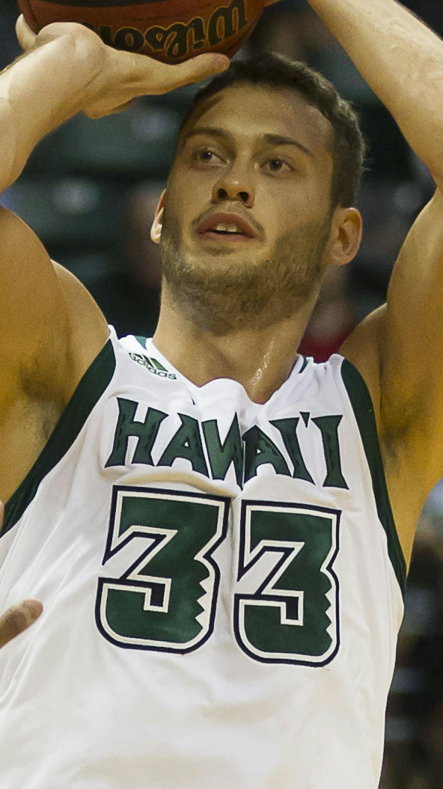 Hawaii forward Stefan Jankovic (33) takes a shot over Colorado forward Josh Scott (40) in the second half of an NCAA college basketball game at the Diamond Head Classic on Thursday, Dec. 25, 2014, in Honolulu. Hawaii beat Colorado 69-66. (AP Photo/Eugene Tanner) ORG XMIT: HIETOTK110