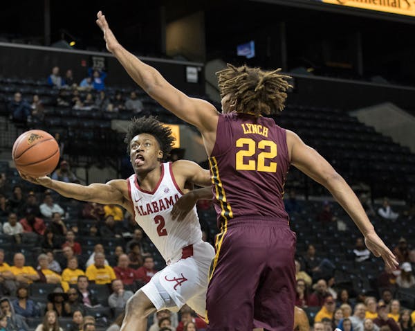 Alabama guard Collin Sexton (2) drives to the basket against Minnesota center Reggie Lynch (22) during the first half of an NCAA college basketball ga