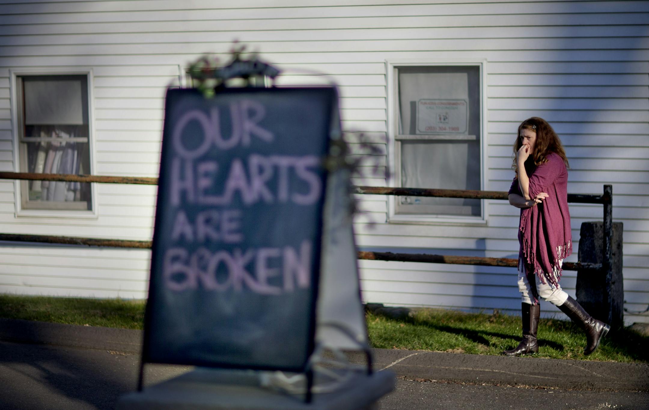 Shop owner Tamara Doherty, paces outside her store just down the road from Sandy Hook Elementary School, Saturday, Dec. 15, 2012, in Newtown, Conn.