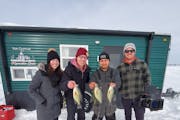 “Rural by Choice” host Cory Hepola (second from left) holds fish he caught with Otter Tail County resident Adan Abarca at Lake Lida, flanked by se