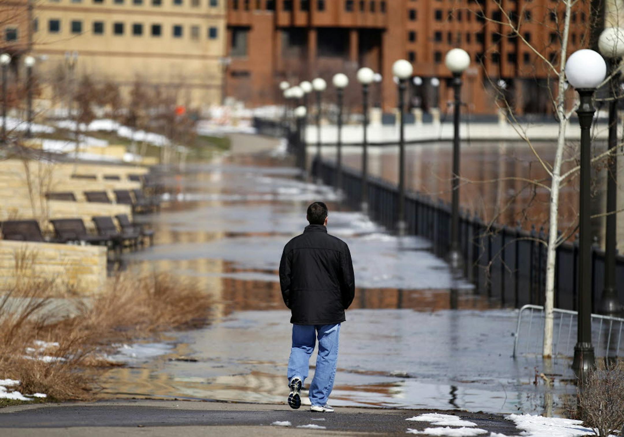 The walking area near the Mississippi River in St. Paul was covered by water on Sunday.