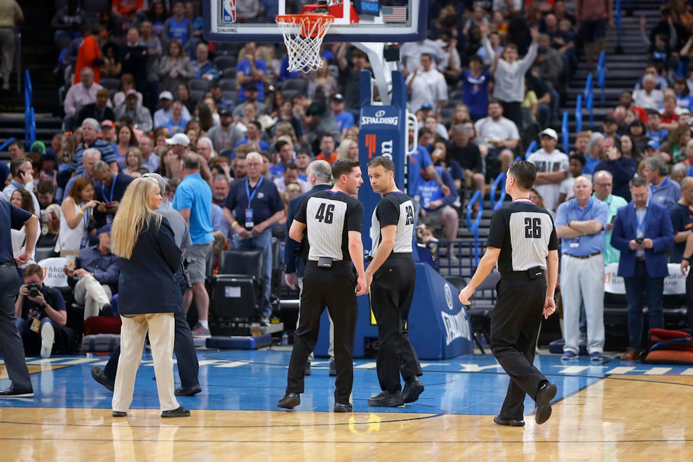 Officials leave the court before an NBA basketball game between the Oklahoma City Thunder and the Utah Jazz was postponed in Oklahoma City, Wednesday, March 11, 2020.(Bryan Terry/The Oklahoman via AP)