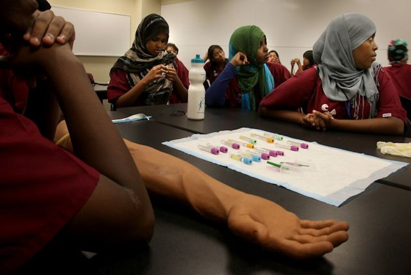 Students learned how to insert an IV into a mock arm during instruction time as part of the Scrubs Camp.