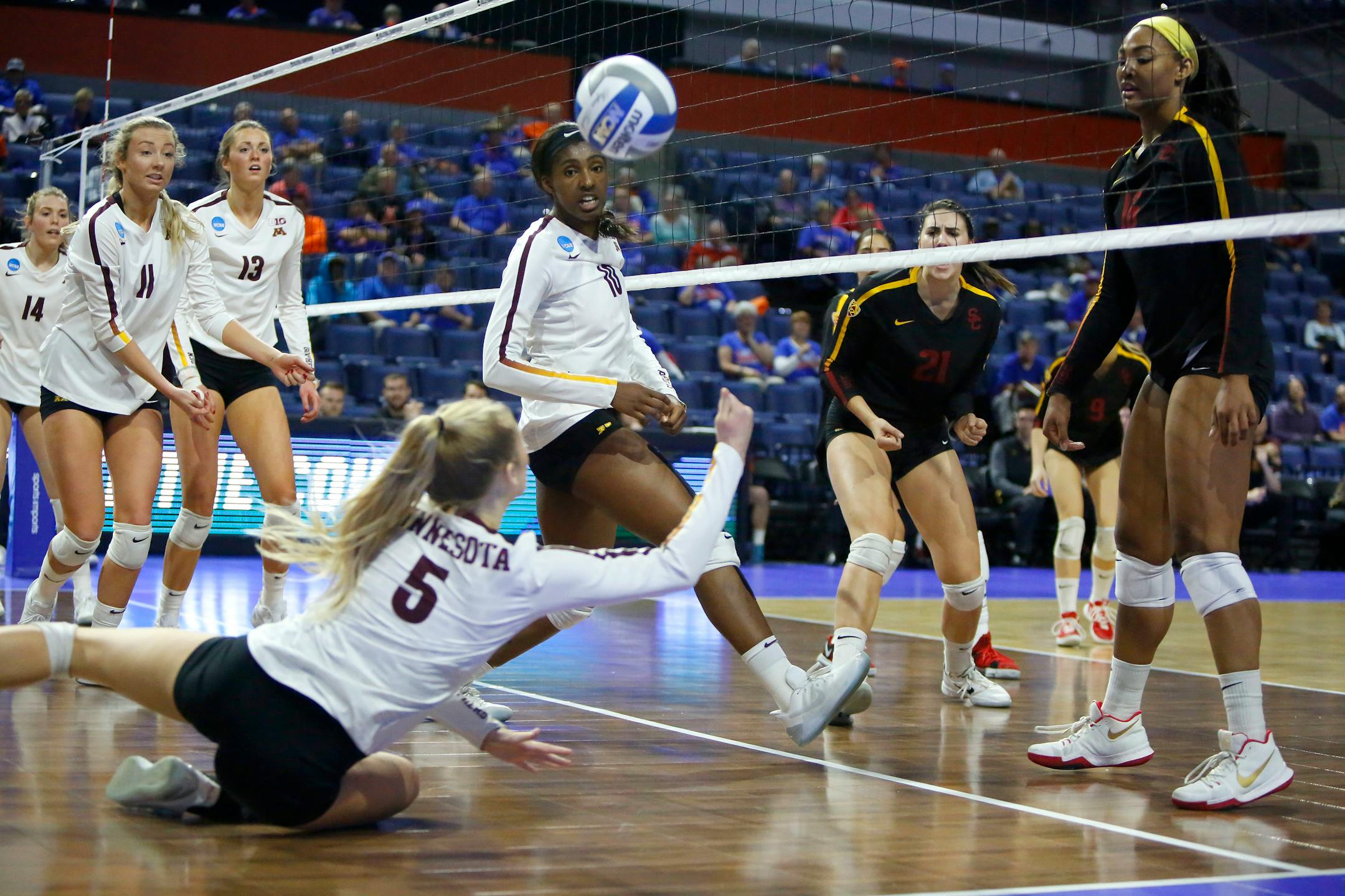 Minnesota Gophers' Alyssa Goehner (5) dives to dig a ball up during the Regional Semi-Final match against USC in the NCAA Volleyball Championships at the O'Connell Center in Gainesville Friday Dec. 8, 2017. The Gophers lost in straight sets 3-0 to the Trojans.