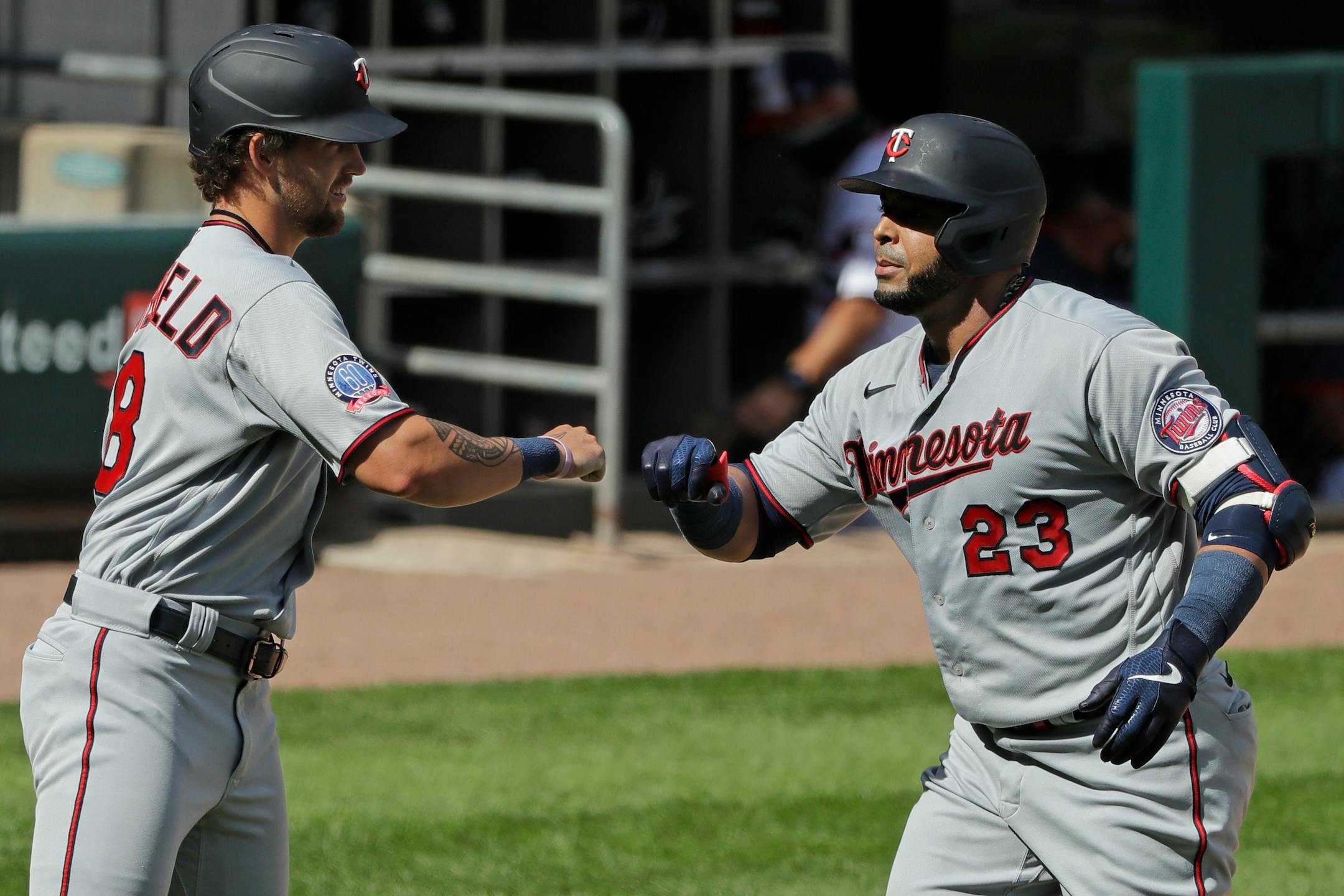 Minnesota Twins' Nelson Cruz, right, celebrates with Aaron Whitefield after hitting a three-run home run during the eighth inning of a baseball game against the Chicago White Sox in Chicago, Sunday, July 26, 2020. (AP Photo/Nam Y. Huh)