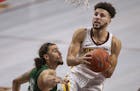 Minnesota Golden Gophers guard Gabe Kalscheur (22) drove to the basket on Cleveland State Vikings guard Tre Gomillion (5) in the second half at Willia