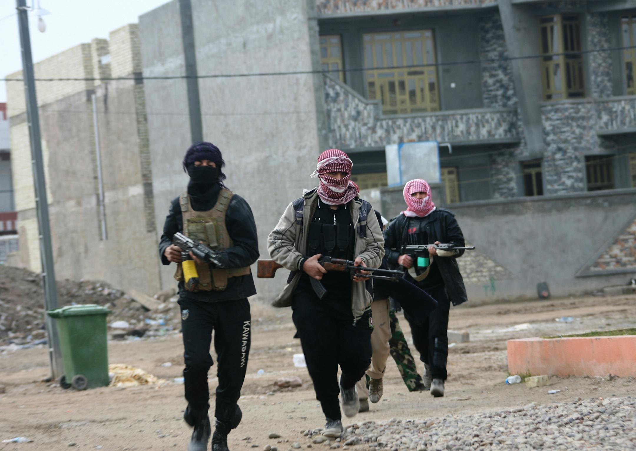 Gunmen patrol during clashes with Iraqi security forces in Fallujah, 40 miles (65 kilometers) west of Baghdad, Iraq, Sunday, Jan. 5, 2014.