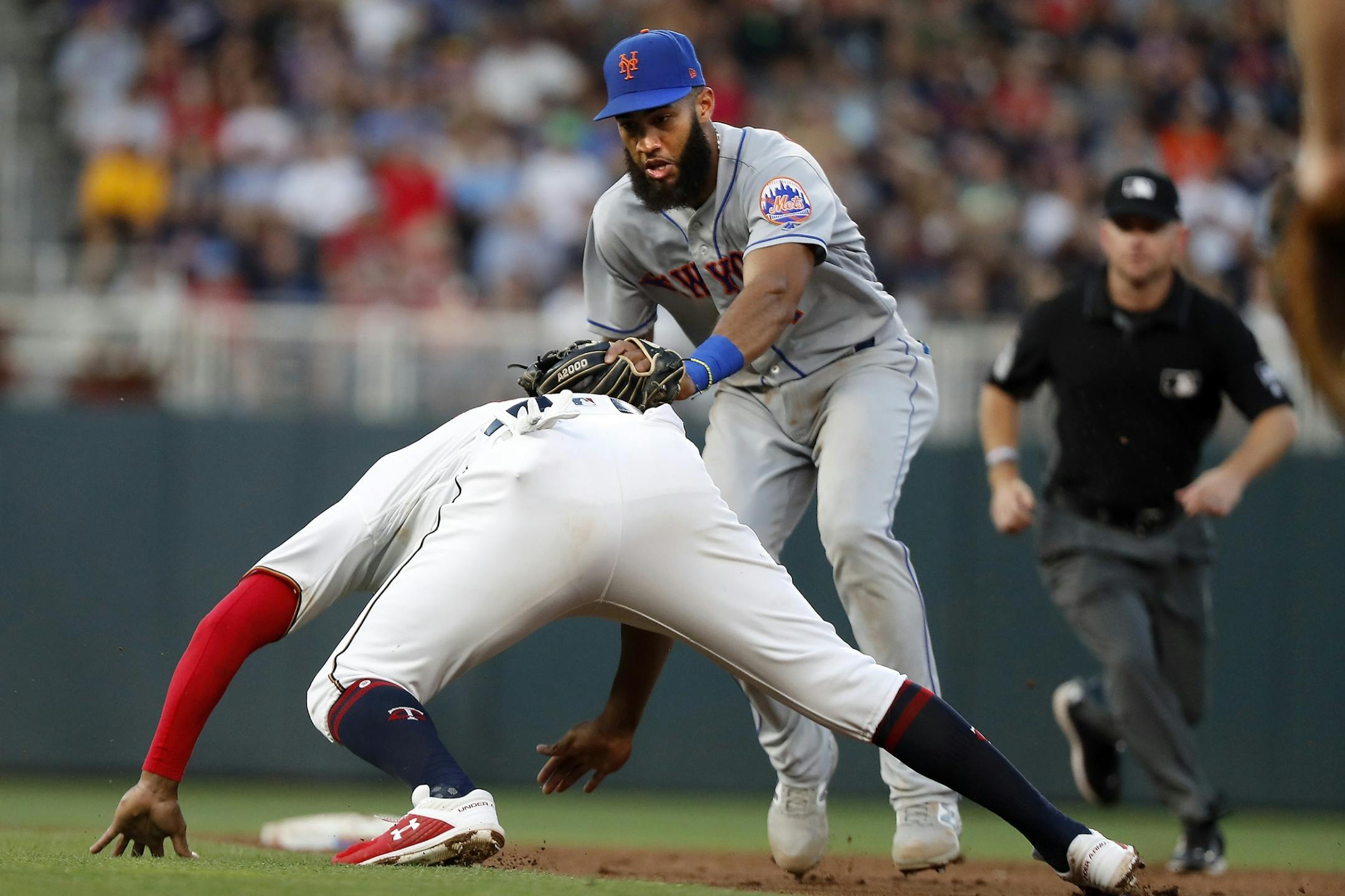 New York Mets shortstop Amed Rosario (1) tags out Minnesota Twins second baseman Jonathan Schoop (16).