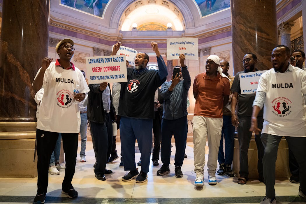 Uber and Lyft drivers rally at the Minnesota State Capitol on Friday, as time is running out for a vote on the bill before Monday's deadline to adjourn. 