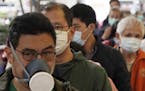 People queue up to buy face masks in Hong Kong, Friday, Feb. 7, 2020. Japan on Friday reported 41 new cases of a virus on a quarantined cruise ship an