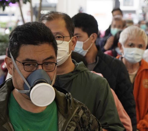 People queue up to buy face masks in Hong Kong, Friday, Feb. 7, 2020. Japan on Friday reported 41 new cases of a virus on a quarantined cruise ship an