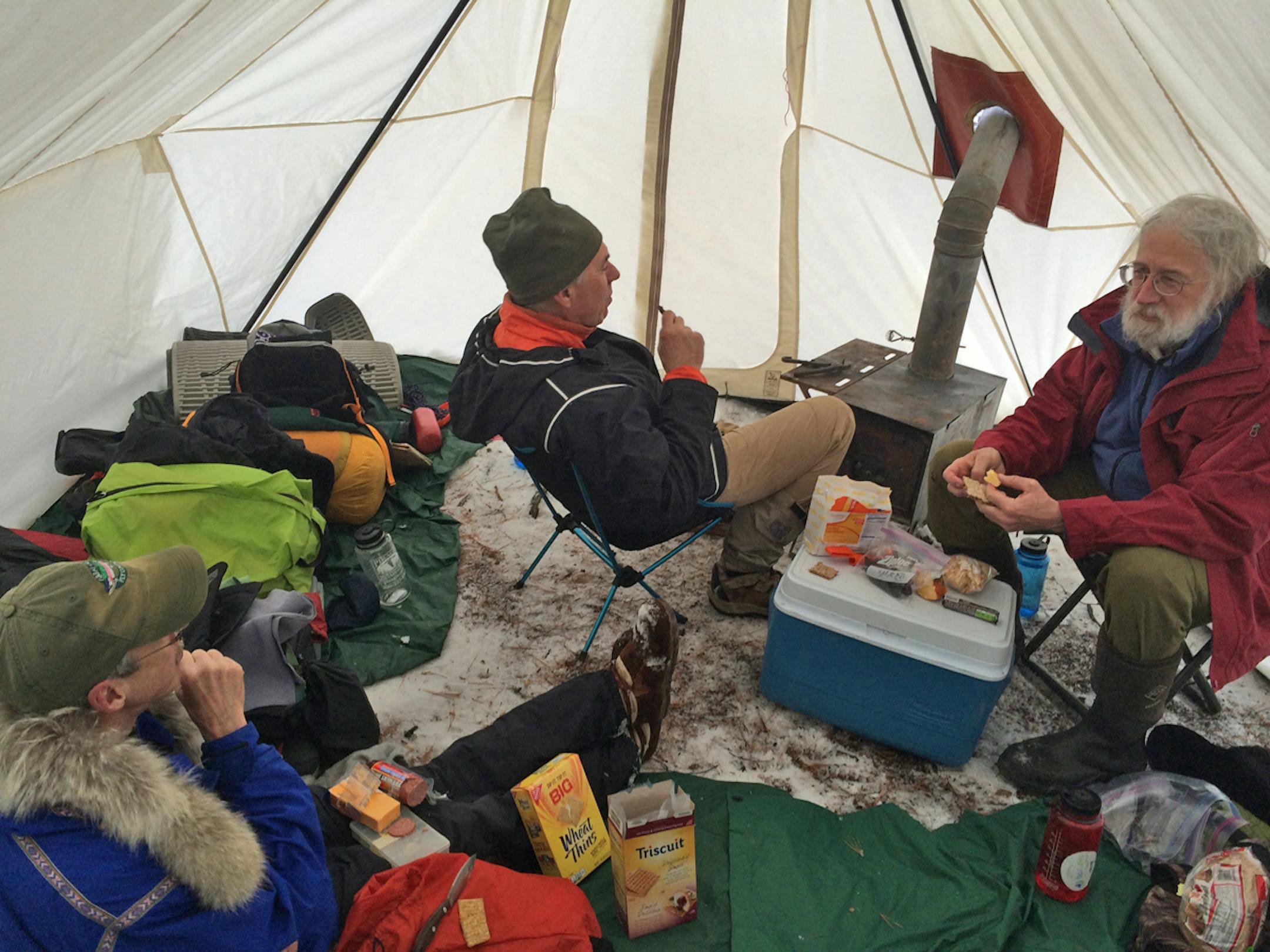Sam Cook, Steve Piragis and Gary Thornbloom eat lunch in their heated canvas tent while winter camping in the BWCA last weekend.