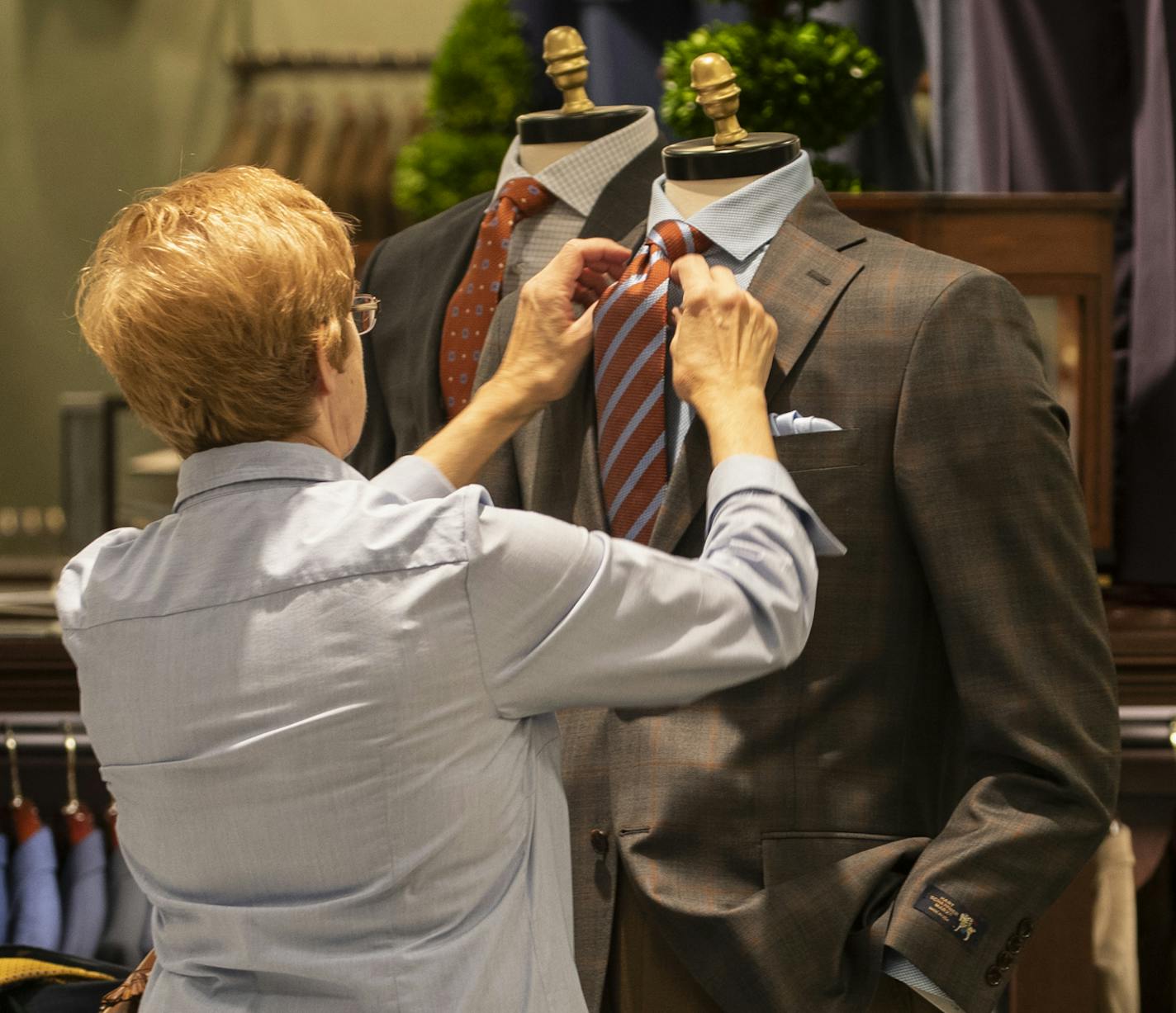 Carol Einertson straightened a tie on a display in the men's section at the new Von Maur store in Roseville, Minn., on Wednesday, October 4, 2018. The store opens October 13. ] RENEE JONES SCHNEIDER &#x2022; renee.jones@startribune.com