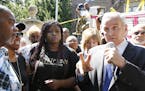 Governor Mark Dayton speaks with Diamond Reynolds the girlfriend of Castile, second from left, during a press conference at his residence regarding th