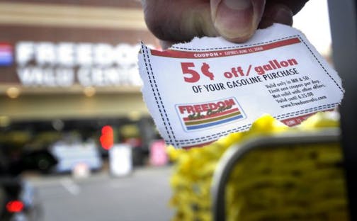 Fuel price spotter Mike Wolf filled his tank at a Freedom Valu Center (cq) in Plymouth and used an online coupon worth 5 cents off per gallon. He checks posted prices along his commute from Maple Grove to Eden Prairie.